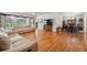 Bright living room with hardwood floors, comfortable seating, and views of the outdoors at 5492 Legend Hills Ln, Spring Hill, FL 34609
