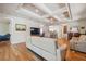 Open living room featuring hardwood floors, bright lighting, and a view to the kitchen at 5492 Legend Hills Ln, Spring Hill, FL 34609