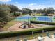 Neighborhood playground and tennis courts with blue playing surface at 5492 Legend Hills Ln, Spring Hill, FL 34609