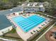 Aerial view of a large pool with plenty of seating and a covered gazebo area at 5492 Legend Hills Ln, Spring Hill, FL 34609