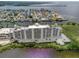 Wonderful aerial view of a white modern condominium building with water views, in a desirable neighborhood at 5915 Sea Ranch Dr # 211, Hudson, FL 34667