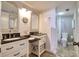 Bathroom featuring dual sink vanity, granite counters and nautical mirror at 5915 Sea Ranch Dr # 211, Hudson, FL 34667