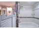 Bright tub/shower combo with decorative tile accents and custom entry door at 5915 Sea Ranch Dr # 211, Hudson, FL 34667