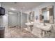 Well-maintained public bathroom with modern tile flooring, partitioned stalls, and square sinks with decorative framed mirrors at 5915 Sea Ranch Dr # 211, Hudson, FL 34667