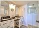 Bathroom with dual sinks, granite countertop, framed mirrors and a view to the shower at 5915 Sea Ranch Dr # 211, Hudson, FL 34667