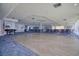 Spacious event space with a wood dance floor, an American flag, a piano, and seating arrangements for various occasions at 5915 Sea Ranch Dr # 211, Hudson, FL 34667
