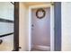 Front door with wreath and 'two eleven' displayed, situated inside a condominium at 5915 Sea Ranch Dr # 211, Hudson, FL 34667