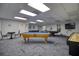 Large game room featuring multiple pool tables, shuffleboard, and a relaxed atmosphere for friendly competition at 5915 Sea Ranch Dr # 211, Hudson, FL 34667