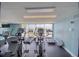 Fully-equipped gym with treadmills and elliptical machines overlooking water view at 5915 Sea Ranch Dr # 211, Hudson, FL 34667
