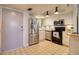 Functional kitchen with stainless steel appliances, white cabinets and tile floors at 5915 Sea Ranch Dr # 211, Hudson, FL 34667