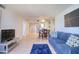 Open-concept living room with tile floors, and a comfortable blue sofa at 5915 Sea Ranch Dr # 211, Hudson, FL 34667