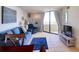 Living room with blue furnishings, tile flooring, and a sliding glass door to a balcony at 5915 Sea Ranch Dr # 211, Hudson, FL 34667