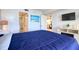 Comfortable primary bedroom with a view to the bathroom and kitchen at 5915 Sea Ranch Dr # 211, Hudson, FL 34667