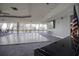 Large meeting room with hardwood dance floor, expansive windows, TV, and American flag in desirable complex at 5915 Sea Ranch Dr # 211, Hudson, FL 34667