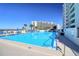 Resort-style swimming pool with tanning deck and palm tree landscaping at 5915 Sea Ranch Dr # 211, Hudson, FL 34667