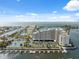 Stunning aerial view of waterfront condominiums and bay views with tennis courts and boat docks at 6035 Sea Ranch Dr # 408, Hudson, FL 34667