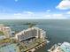 Expansive aerial view of waterfront condominiums with tennis courts and boat docks at 6035 Sea Ranch Dr # 408, Hudson, FL 34667