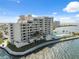 Exterior of bayfront condo community with pool, lush landscaping, and parking spaces visible at 6035 Sea Ranch Dr # 408, Hudson, FL 34667