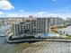 Aerial view of a waterfront condo community featuring a pool and boat docks in a beautiful bay setting at 6035 Sea Ranch Dr # 408, Hudson, FL 34667