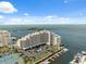 Aerial view of waterfront condominiums with private boat docks, tennis courts, and bay views at 6035 Sea Ranch Dr # 408, Hudson, FL 34667