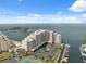 Aerial view of waterfront condominiums with private boat docks, tennis courts, and ample parking at 6035 Sea Ranch Dr # 408, Hudson, FL 34667