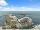 An aerial of a condo community with tennis courts, parking, and boat slips near the beautiful bay at 6035 Sea Ranch Dr # 408, Hudson, FL 34667