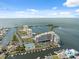 An aerial showing tennis courts, buildings, boat slips, and parking for this bayfront condo community at 6035 Sea Ranch Dr # 408, Hudson, FL 34667