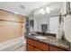 Cozy bathroom with tiled shower, vanity, and ample storage space at 6035 Sea Ranch Dr # 408, Hudson, FL 34667