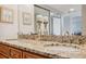 A full bath with a double-sink granite counter, tile floors and ornate decor at 6035 Sea Ranch Dr # 408, Hudson, FL 34667