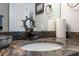 Close-up of bathroom sink with granite countertop, bronze faucet and ship wheel decor at 6035 Sea Ranch Dr # 408, Hudson, FL 34667