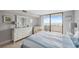 Bedroom featuring a large balcony and beach view, natural light, and calming color scheme at 6035 Sea Ranch Dr # 408, Hudson, FL 34667