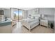 Bright bedroom with a balcony, tile flooring, and calming light-blue color scheme at 6035 Sea Ranch Dr # 408, Hudson, FL 34667