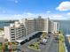 Well-maintained building exterior complemented by lush landscaping, convenient parking, and stunning waterfront views at 6035 Sea Ranch Dr # 408, Hudson, FL 34667