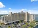A large condo building near the water features covered parking, palms, and nice landscaping at 6035 Sea Ranch Dr # 408, Hudson, FL 34667