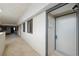 Condo 408 sits at the end of a long hallway with tile floors and muted white walls at 6035 Sea Ranch Dr # 408, Hudson, FL 34667