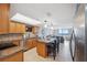 Kitchen with oak cabinets, island, and an eat in bar that's open to living space and water views at 6035 Sea Ranch Dr # 408, Hudson, FL 34667