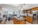 Kitchen opens up to living and dining areas and features an island, oak cabinets and granite counters at 6035 Sea Ranch Dr # 408, Hudson, FL 34667