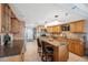 Kitchen features light oak cabinets, stainless appliances, island, and tile backsplash at 6035 Sea Ranch Dr # 408, Hudson, FL 34667
