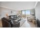 Bright living room features sliding glass doors to a patio with beautiful sky views and tile floors at 6035 Sea Ranch Dr # 408, Hudson, FL 34667