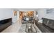 An open-concept living room and dining area featuring wood cabinets and comfortable seating at 6035 Sea Ranch Dr # 408, Hudson, FL 34667