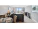 Bright living room features sliding glass doors to a patio with beautiful sky views at 6035 Sea Ranch Dr # 408, Hudson, FL 34667