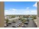 This exterior view showcases the parking lot with tropical landscaping and a scenic view of the harbor at 6035 Sea Ranch Dr # 408, Hudson, FL 34667