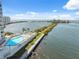 Condo community pool with chairs overlooking the bay under a clear blue sky at 6035 Sea Ranch Dr # 408, Hudson, FL 34667