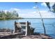 Outdoor seating area with a concrete bench overlooking the bay at 6035 Sea Ranch Dr # 408, Hudson, FL 34667