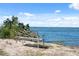 Outdoor seating area with an ornate bench overlooking the bay at 6035 Sea Ranch Dr # 408, Hudson, FL 34667