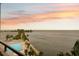 A stunning sunset view overlooks the pool and ocean, creating a serene and picturesque scene at 6035 Sea Ranch Dr # 408, Hudson, FL 34667