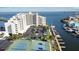 Aerial view featuring a condo complex, tennis courts, marina, and waterfront views at 6035 Sea Ranch Dr # 411, Hudson, FL 34667