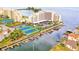 Aerial view of waterfront condos, marina, tennis courts, and lush landscaping at 6035 Sea Ranch Dr # 411, Hudson, FL 34667