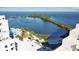 Stunning aerial view showcases the pool, waterfront views, and lush landscaping of this bayside condo community at 6035 Sea Ranch Dr # 411, Hudson, FL 34667