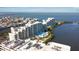 Aerial view of condo community near the water with blue skies and a community pool at 6035 Sea Ranch Dr # 411, Hudson, FL 34667